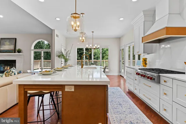 a view of a dining room with furniture a chandelier and wooden floor