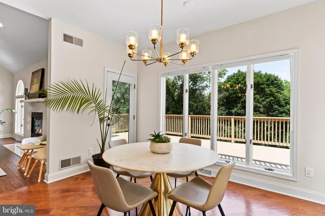 a large white kitchen with a large window and stainless steel appliances
