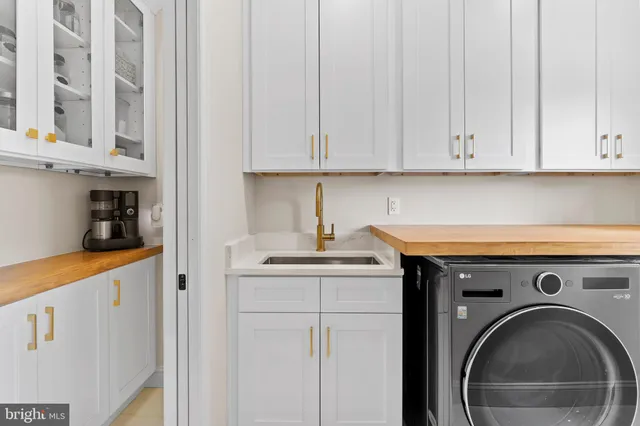 a white bath tub sitting next to a bathroom sink