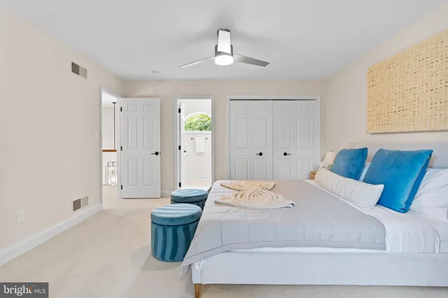a bedroom with a large bed and a chandelier
