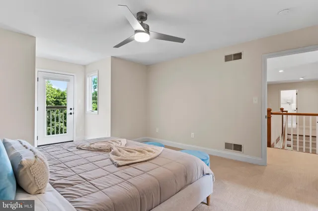a dining room with furniture and potted plants