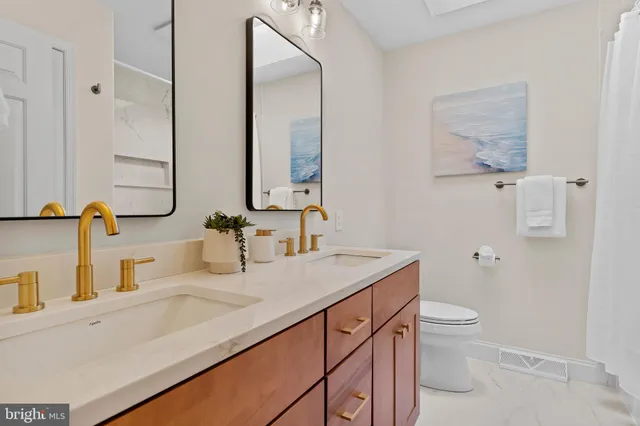 a view of kitchen with kitchen island a stove a sink a potted plant and a window