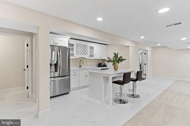 a kitchen with sink a stove and cabinets