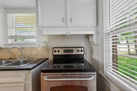 a kitchen with a stove and a sink