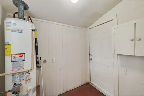 a view of storage and utility room with a refrigerator