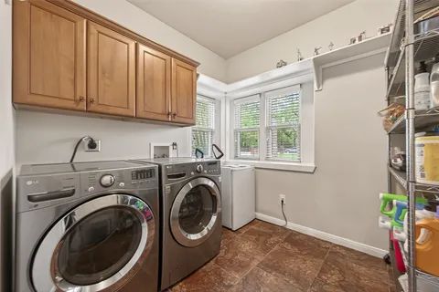 a utility room with sink dryer and washer
