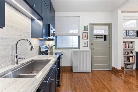 a view of open kitchen with wooden floor