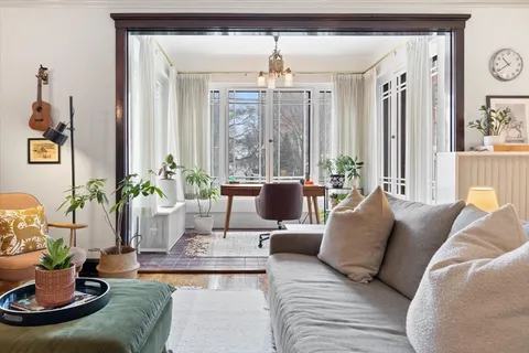a living room with furniture and a chandelier
