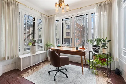 a view of a workspace with furniture and a potted plant