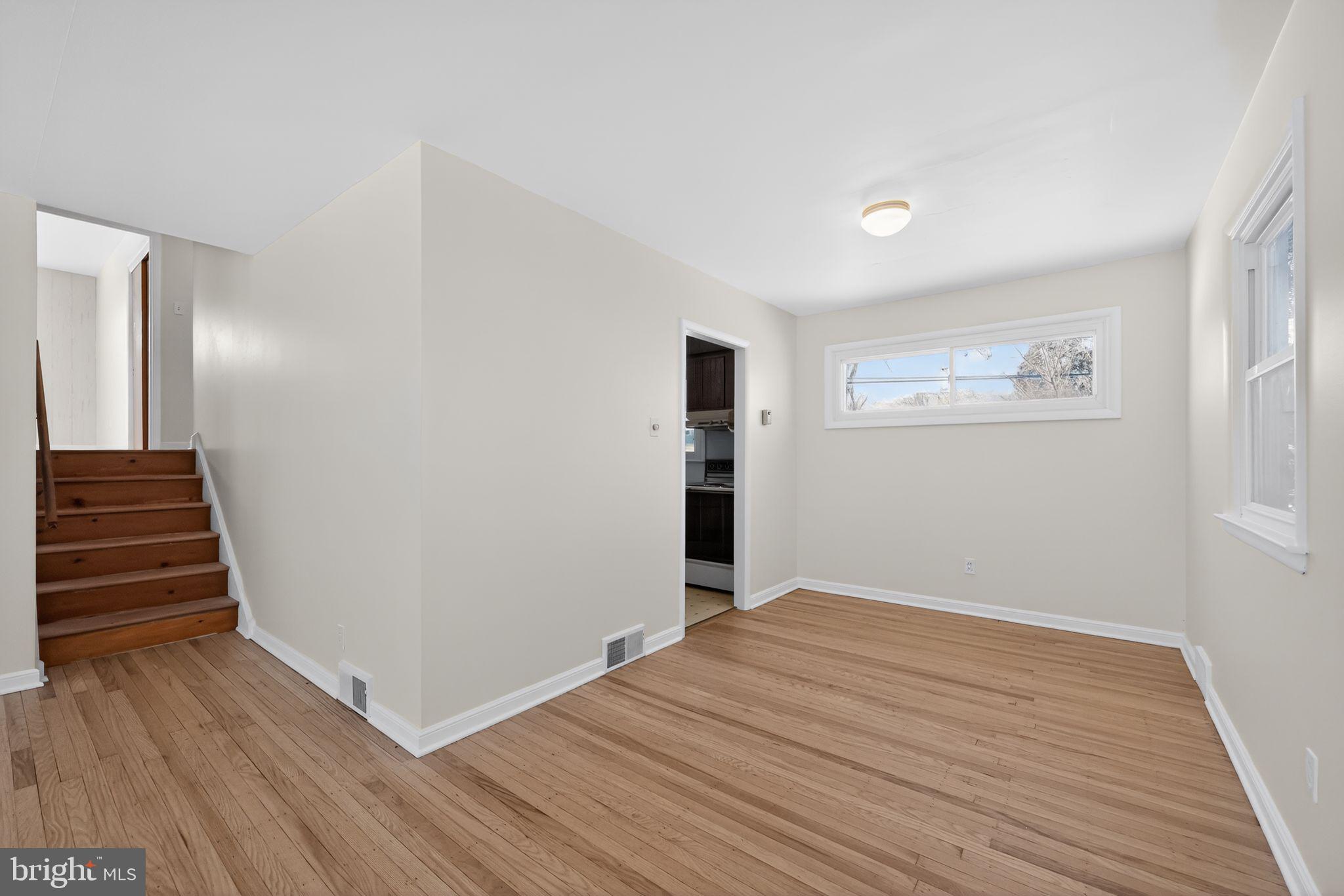 205 Willard Road Hatboro, PA 19040 - Photo 11 of 30 a view of an empty room with wooden floor and stairs
