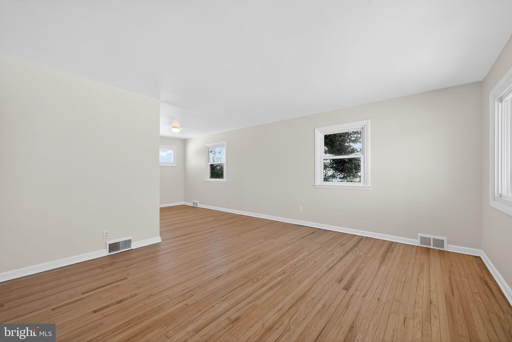205 Willard Road Hatboro, PA 19040 - Photo 12 of 30 an empty room with wooden floor and windows