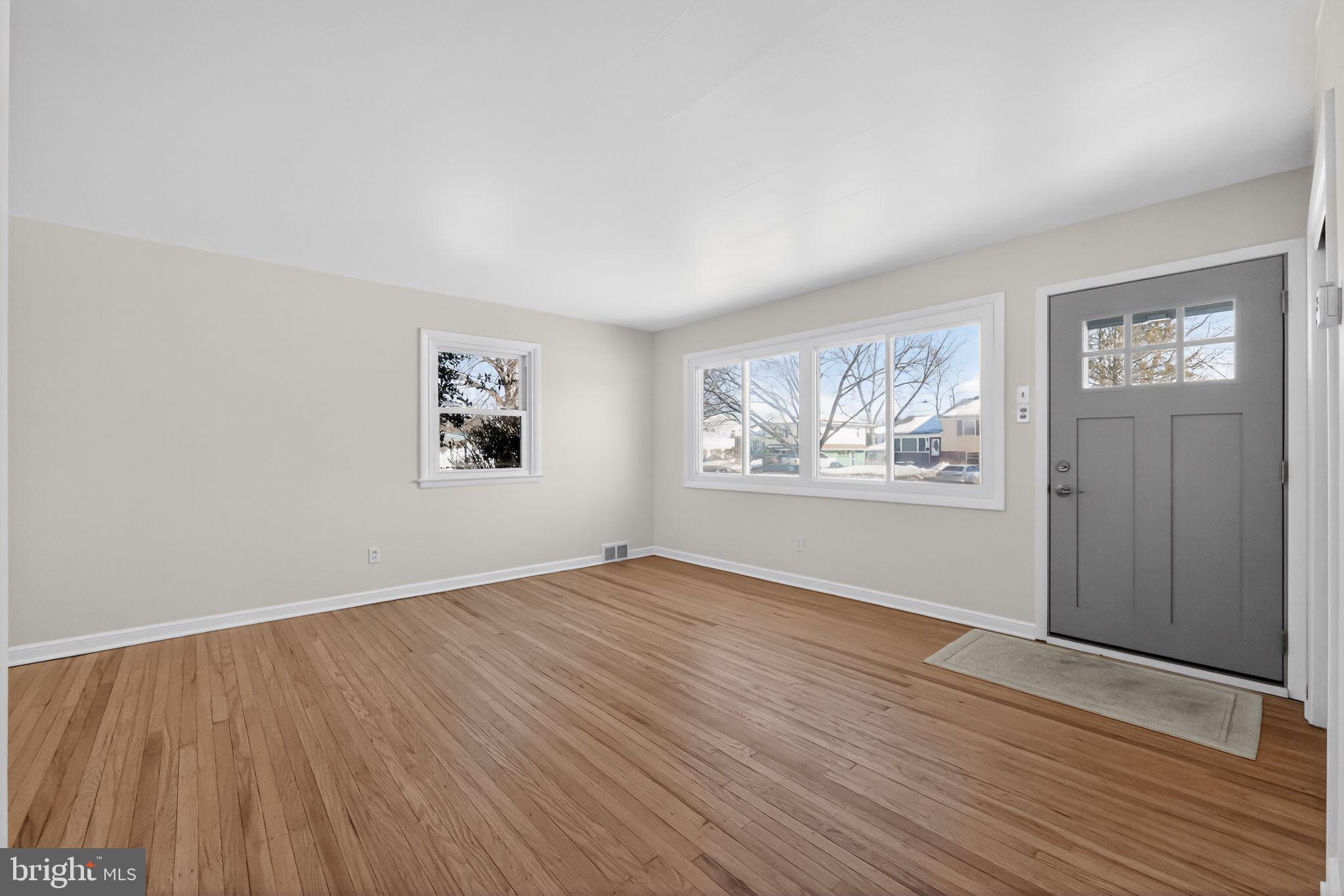 205 Willard Road Hatboro, PA 19040 - Photo 3 of 30 an empty room with wooden floor and windows