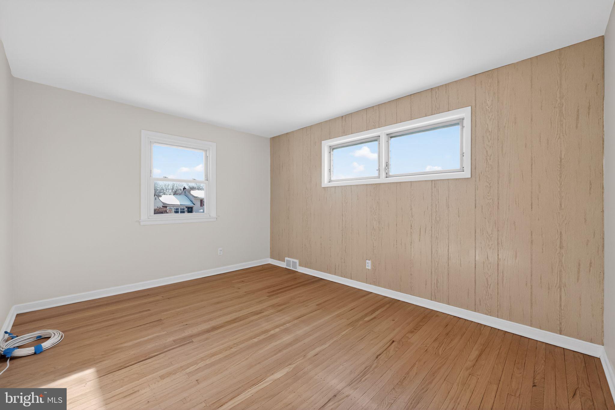 205 Willard Road Hatboro, PA 19040 - Photo 8 of 30 a view of an empty room with wooden floor and a window