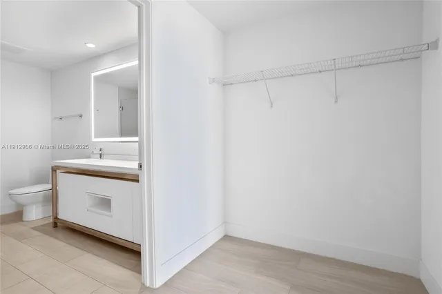 a bathroom with a sink a toilet and vanity