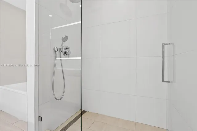 a bathroom with a glass shower door