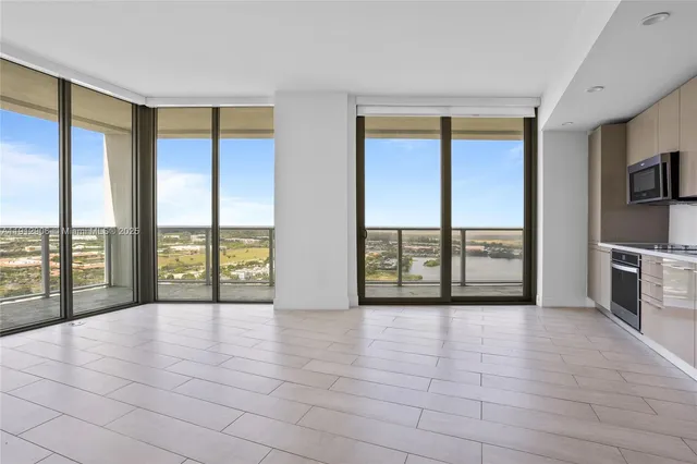 a view of an empty room with a fireplace and a large window