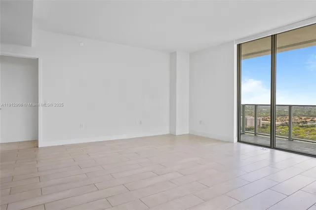 an empty room with sliding glass door