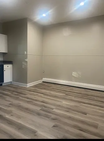 a view of a room with wooden floor