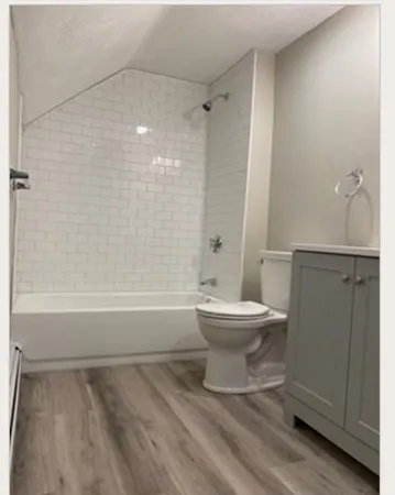 a bathroom with a toilet and a shower