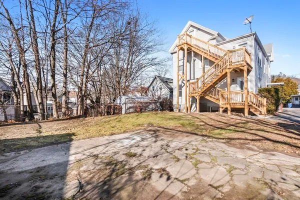 a view of a yard with wooden fence