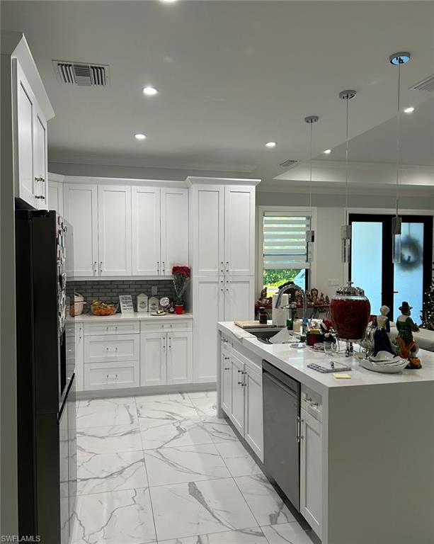 3486 40th Avenue Southeast Naples, FL 34117 - Photo 20 of 50 a kitchen with stainless steel appliances kitchen island granite countertop a sink and cabinets
