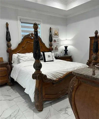 a bedroom with a bed and a lamp on dresser