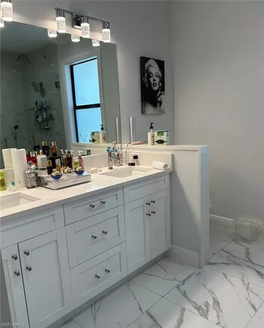 a bathroom with a double vanity sink mirror and