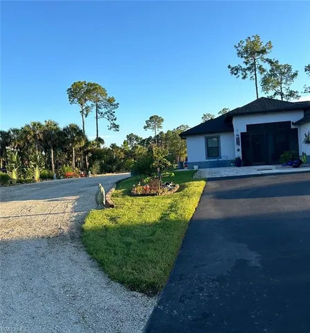 a view of a house with pool yard and a patio