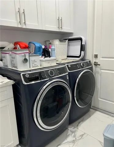 a utility room with sink dryer and washer