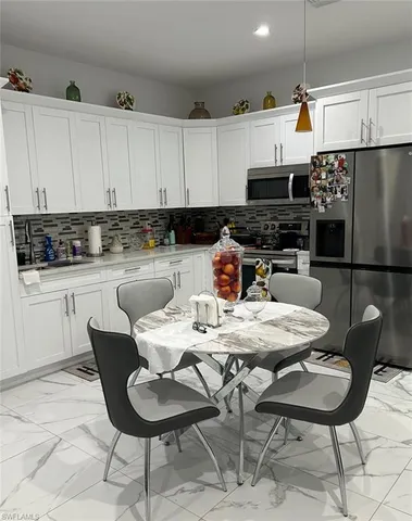 a kitchen with a dining table and chairs