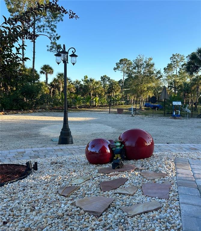 3486 40th Avenue Southeast Naples, FL 34117 - Photo 44 of 50 a view of a wooden floor with a fire pit