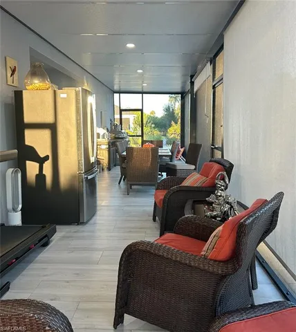 a living room with furniture and a floor to ceiling window