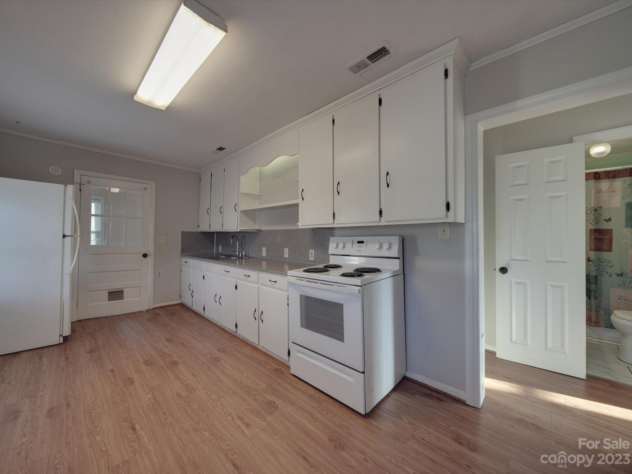 3319 Stack Road Monroe, NC 28112 - Photo 22 of 45 a kitchen with stainless steel appliances white cabinets and wooden floors