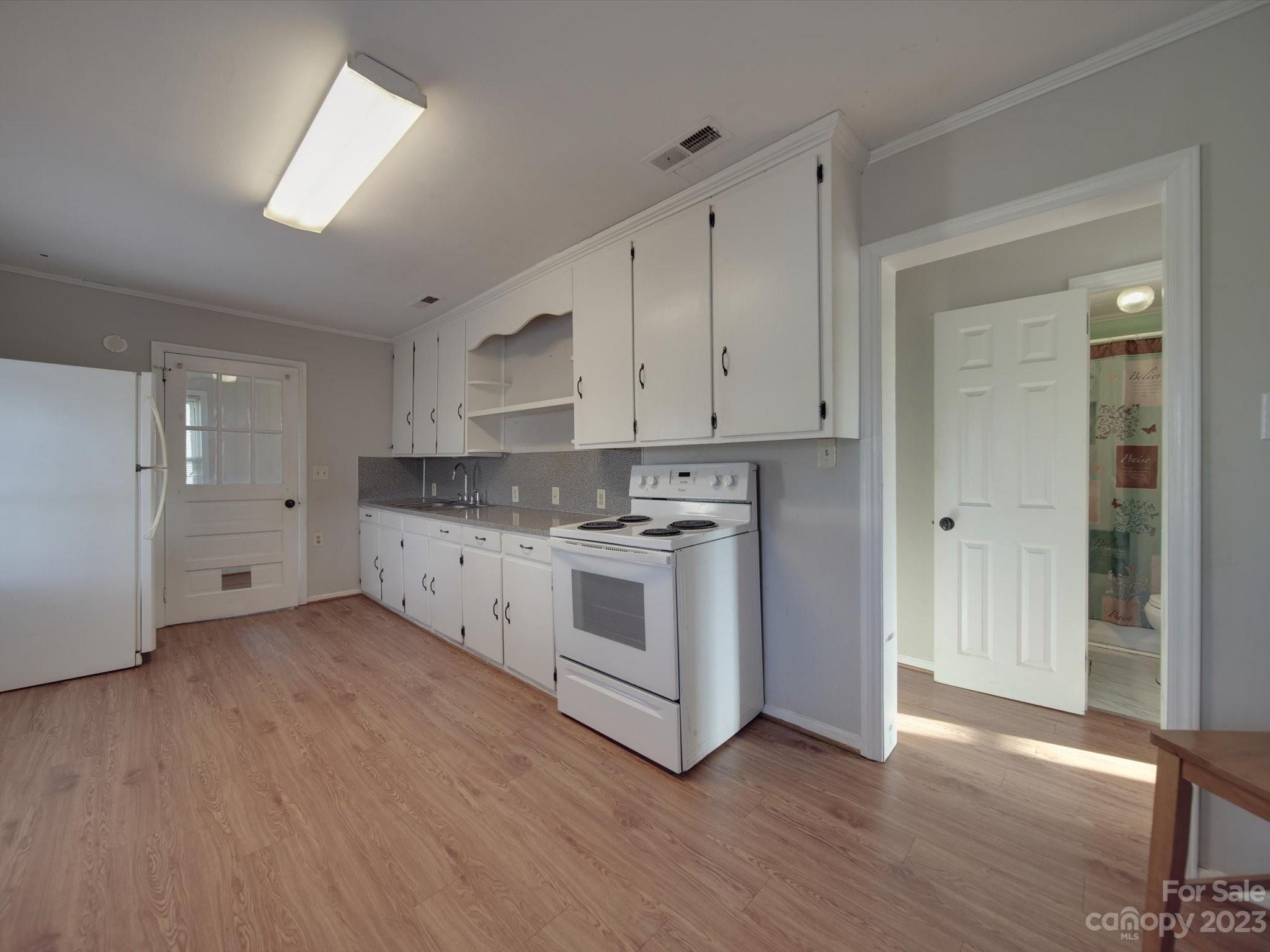 3319 Stack Road Monroe, NC 28112 - Photo 31 of 45 a kitchen with stainless steel appliances white cabinets and wooden floors