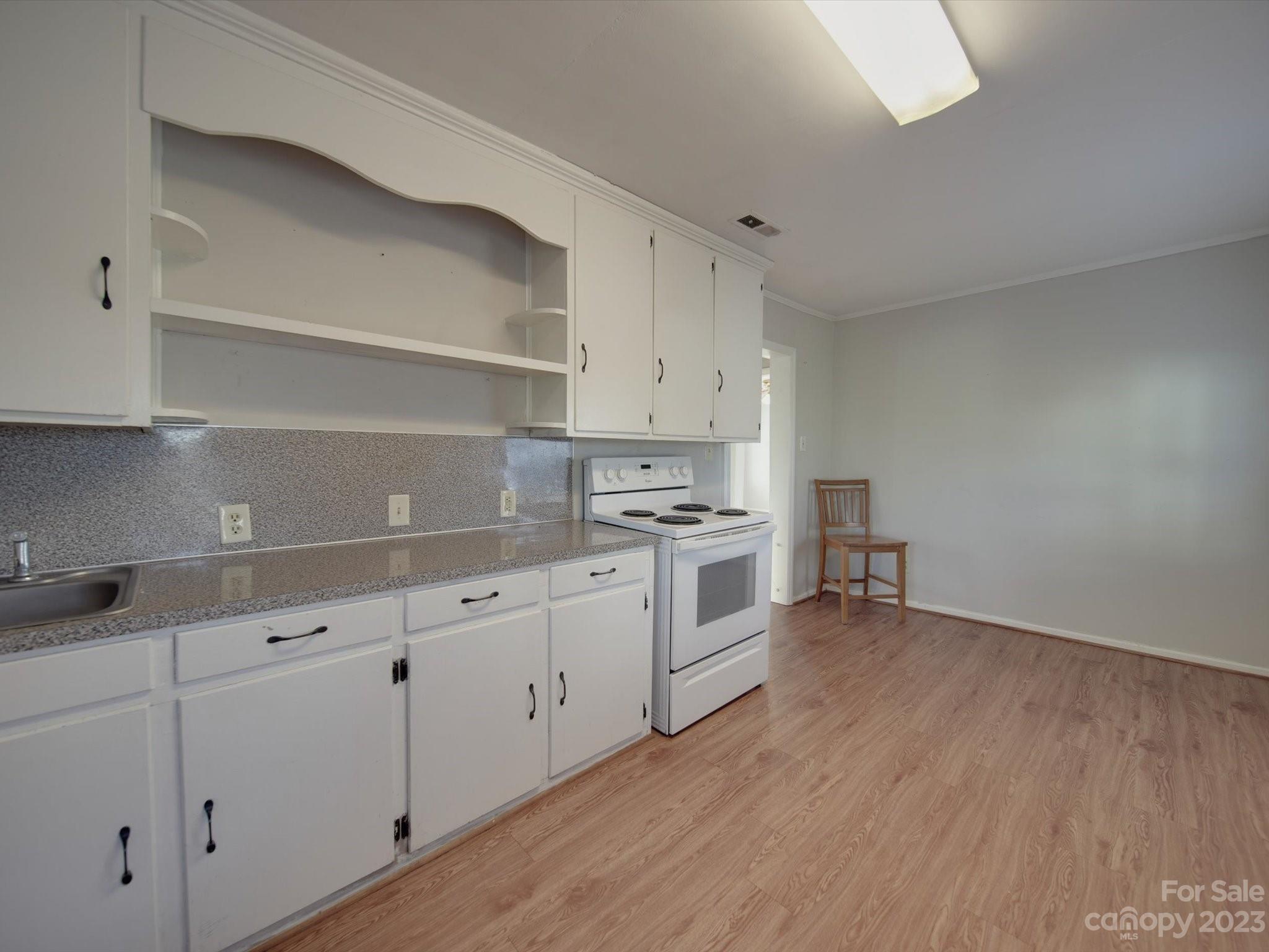 3319 Stack Road Monroe, NC 28112 - Photo 32 of 45 a kitchen with granite countertop white cabinets and white appliances