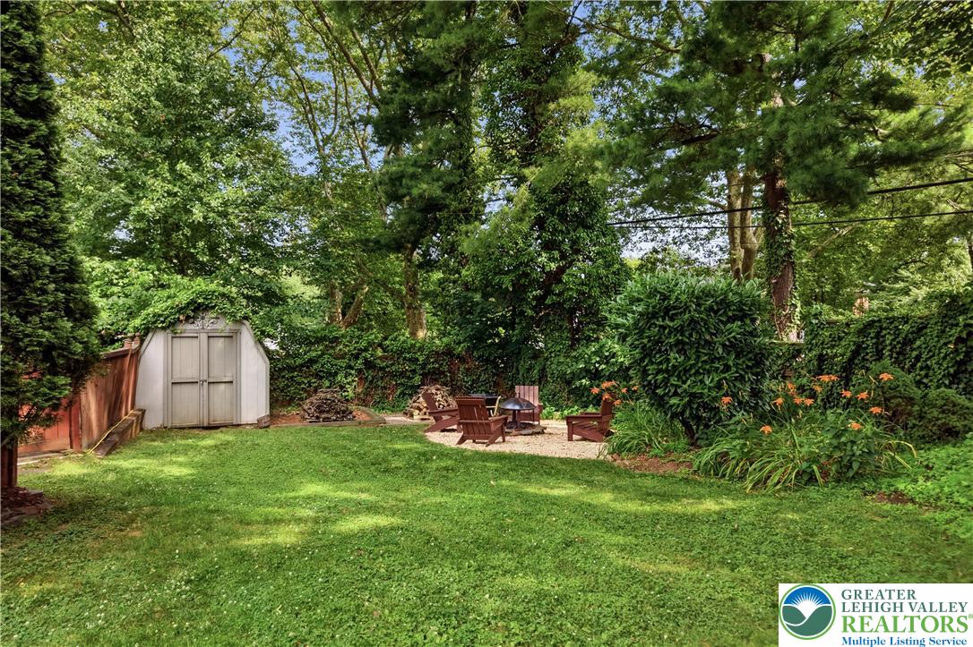 2014 Linden Street Bethlehem, PA 18017 - Photo 63 of 85 A verdant outdoor sanctuary awaits, complete with a cozy fire pit and a practical storage shed.
