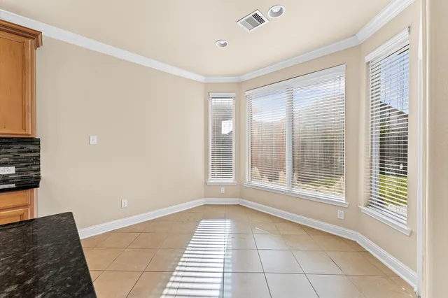 a front view of a house with a yard table and chairs