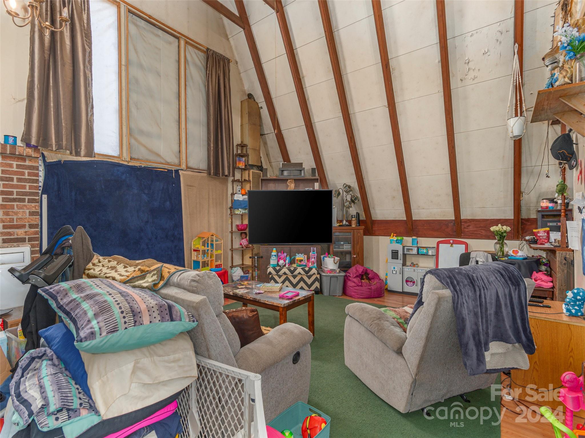 402 Sand Hill Road Asheville, NC 28806 - Photo 2 of 9 a bedroom with furniture and a flat screen tv