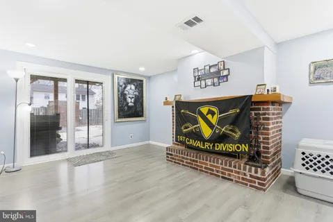 a living room with furniture gym equipment and a flat screen tv