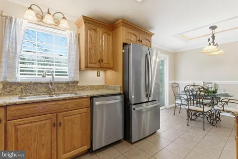 a kitchen with stainless steel appliances granite countertop a refrigerator and a stove