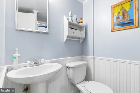 a white toilet sitting next to a bathroom sink