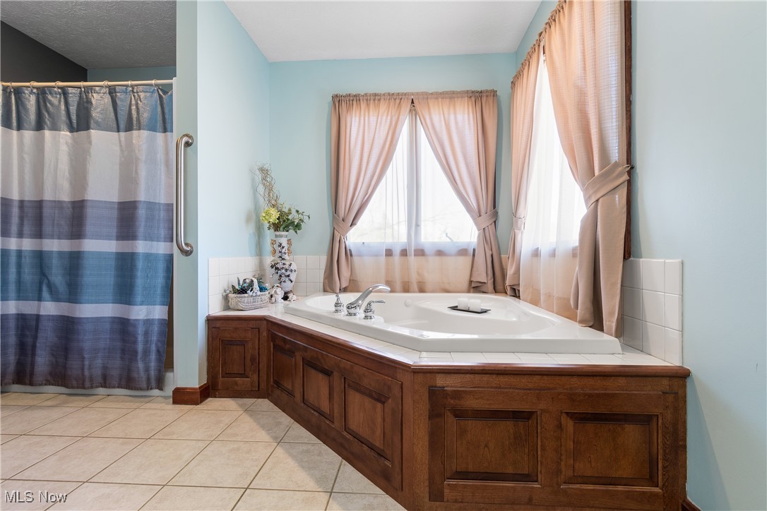 3393 Friendsville Road Wooster, OH 44691 - Photo 16 of 34 Full bathroom featuring curtained shower, tile patterned flooring, and a bath