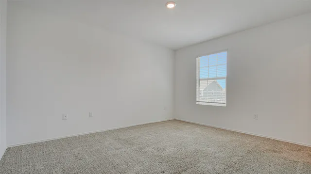 a view of an empty room with a kitchen
