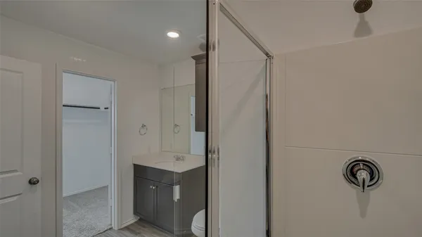 a bathroom with a granite countertop sink toilet and shower
