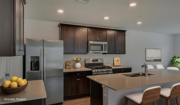 a kitchen with stainless steel appliances granite countertop a sink refrigerator and cabinets