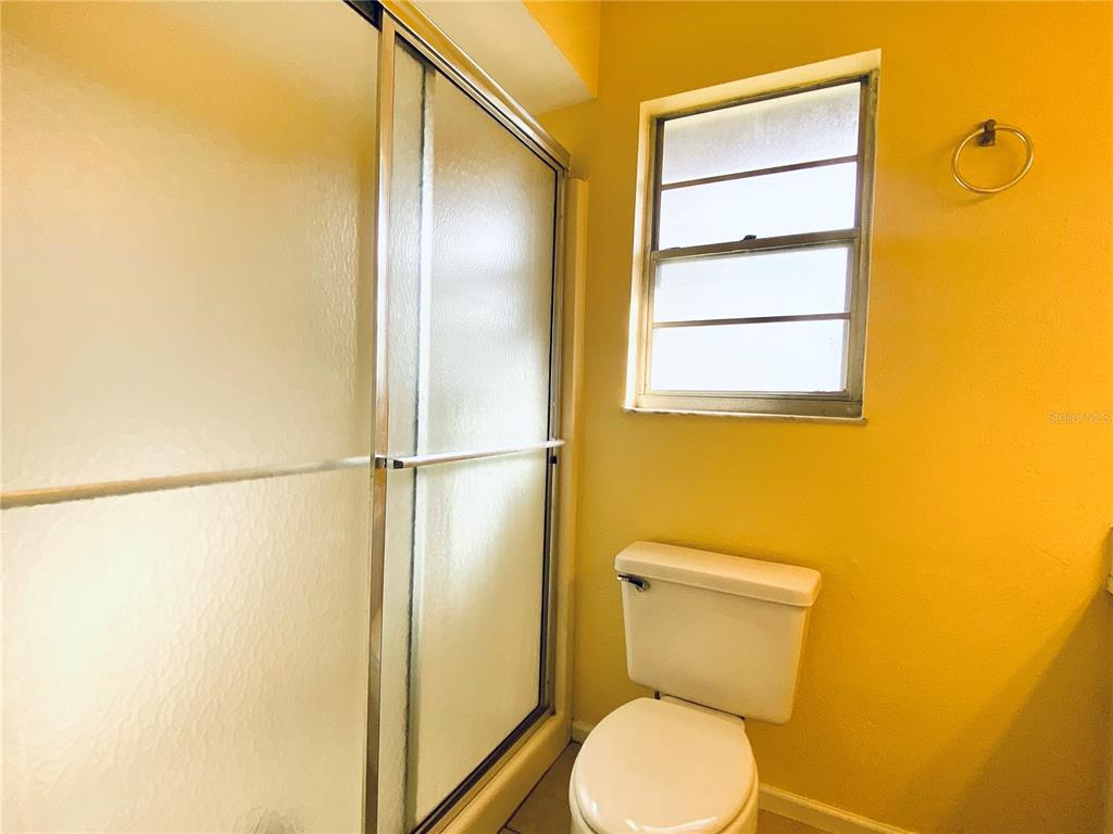 64 Windtree Lane, Unit 203 Winter Garden, FL 34787 - Photo 13 of 13 a bathroom with a toilet and a glass window