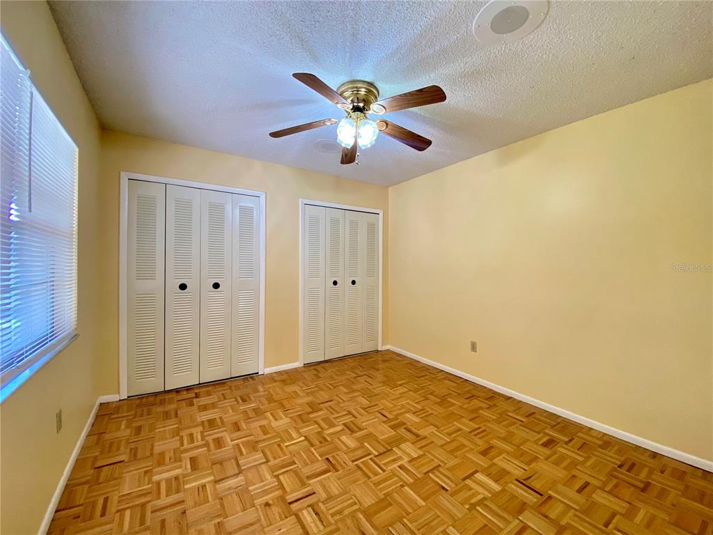 64 Windtree Lane, Unit 203 Winter Garden, FL 34787 - Photo 8 of 13 a view of a big room with wooden floor and a chandelier fan
