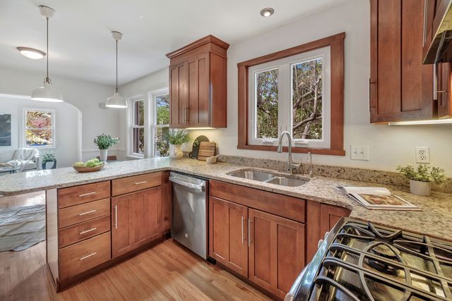 a kitchen with a sink stove and cabinets