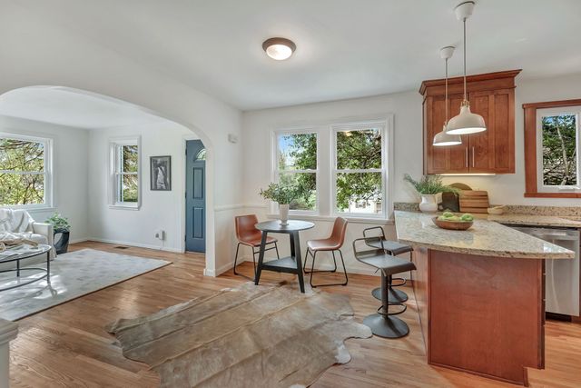 a living room with furniture a window and dining table