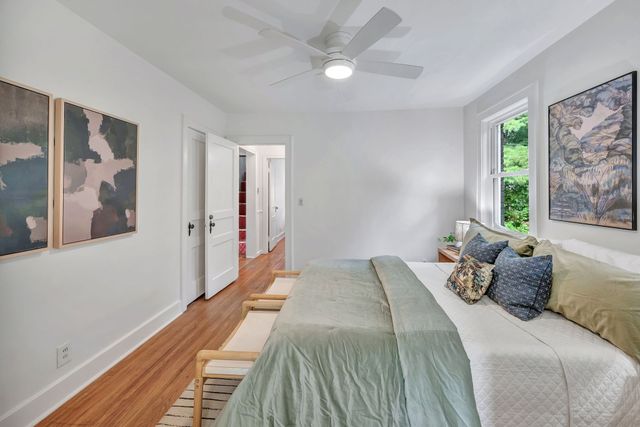 a bedroom with a bed and a large window with outer view
